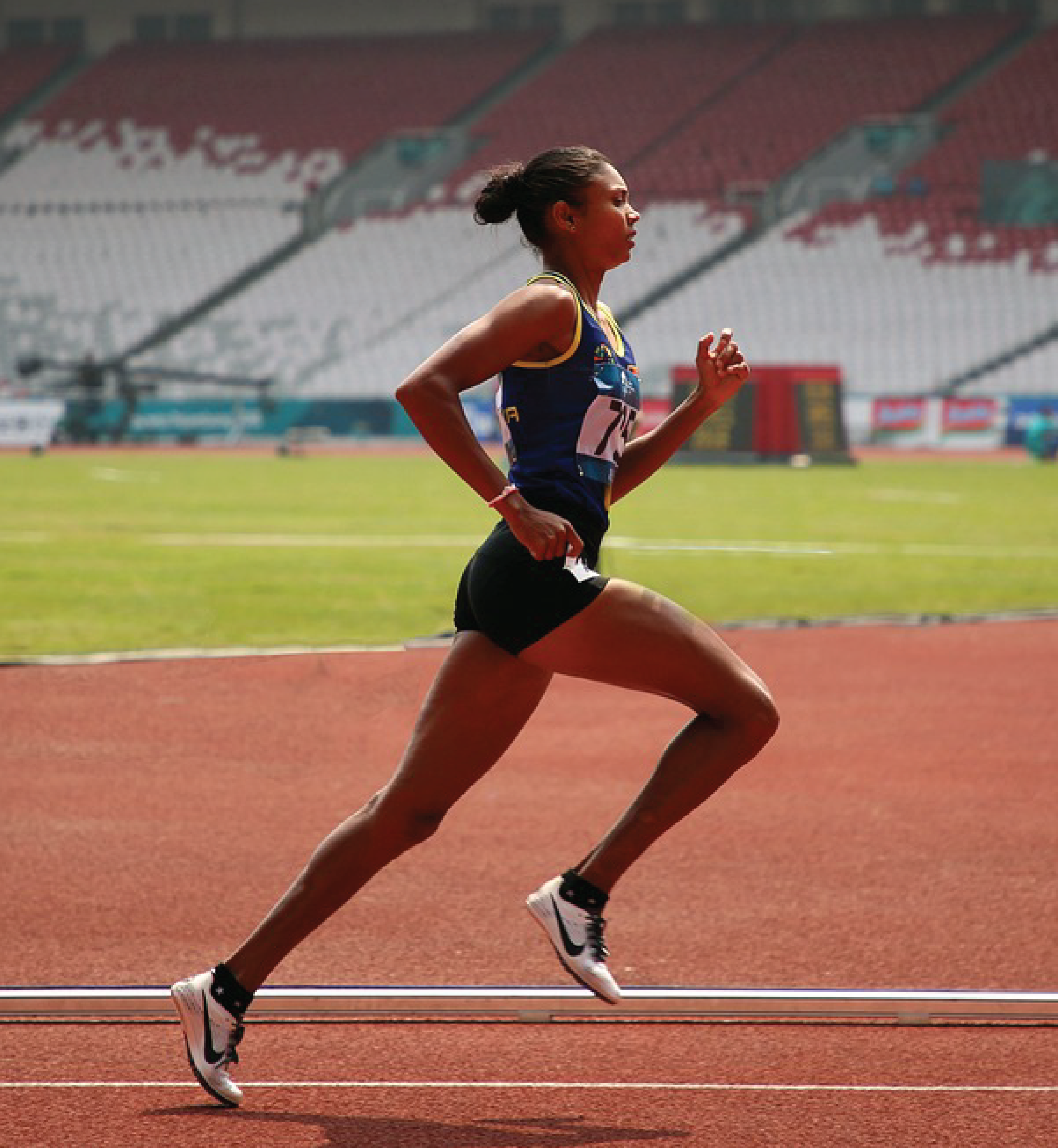 Image of an athlete running on a race track.