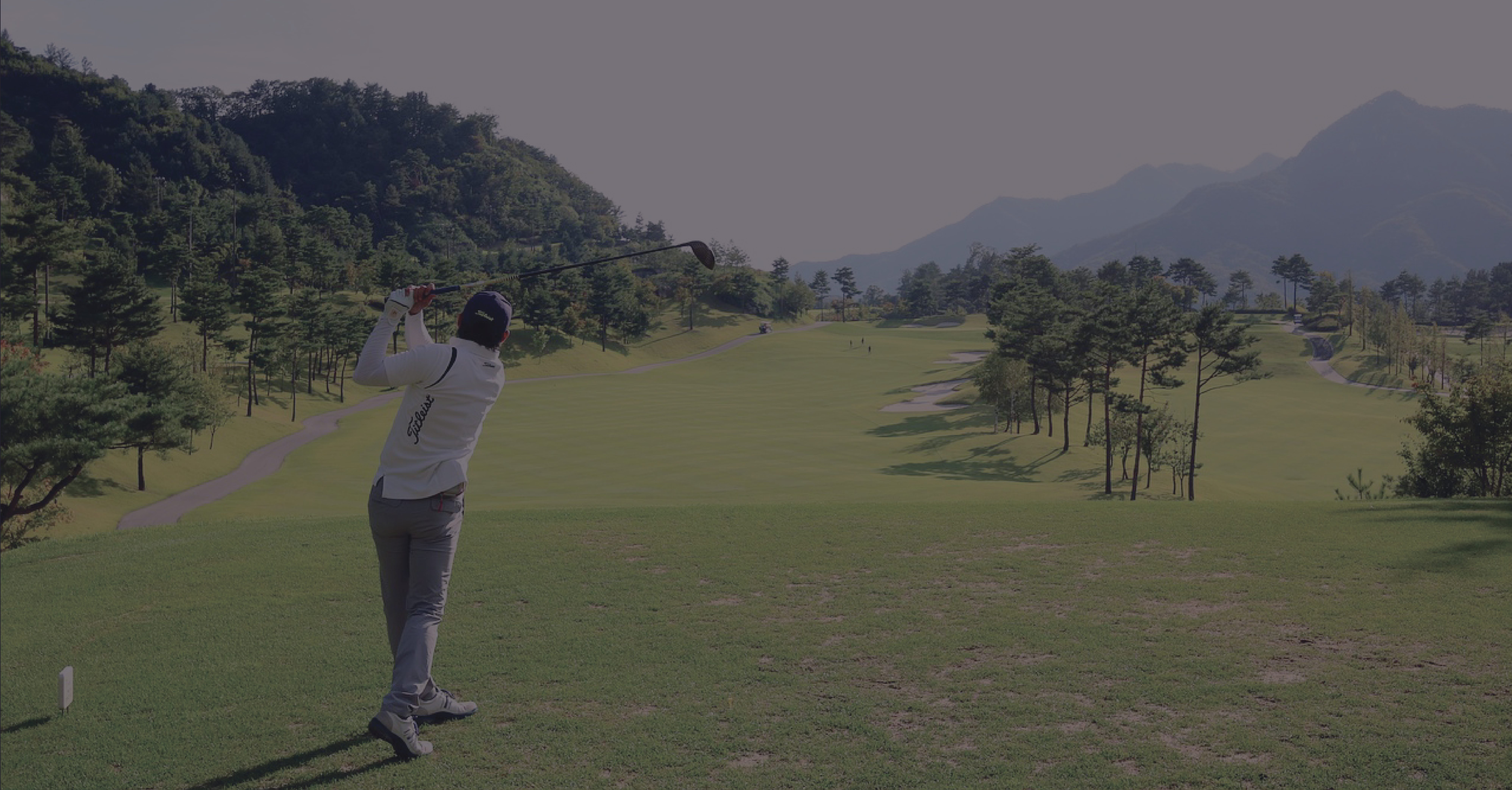 Man at a golf course making a swing