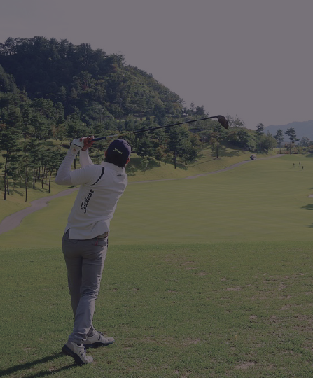 Man at a golf course making a swing